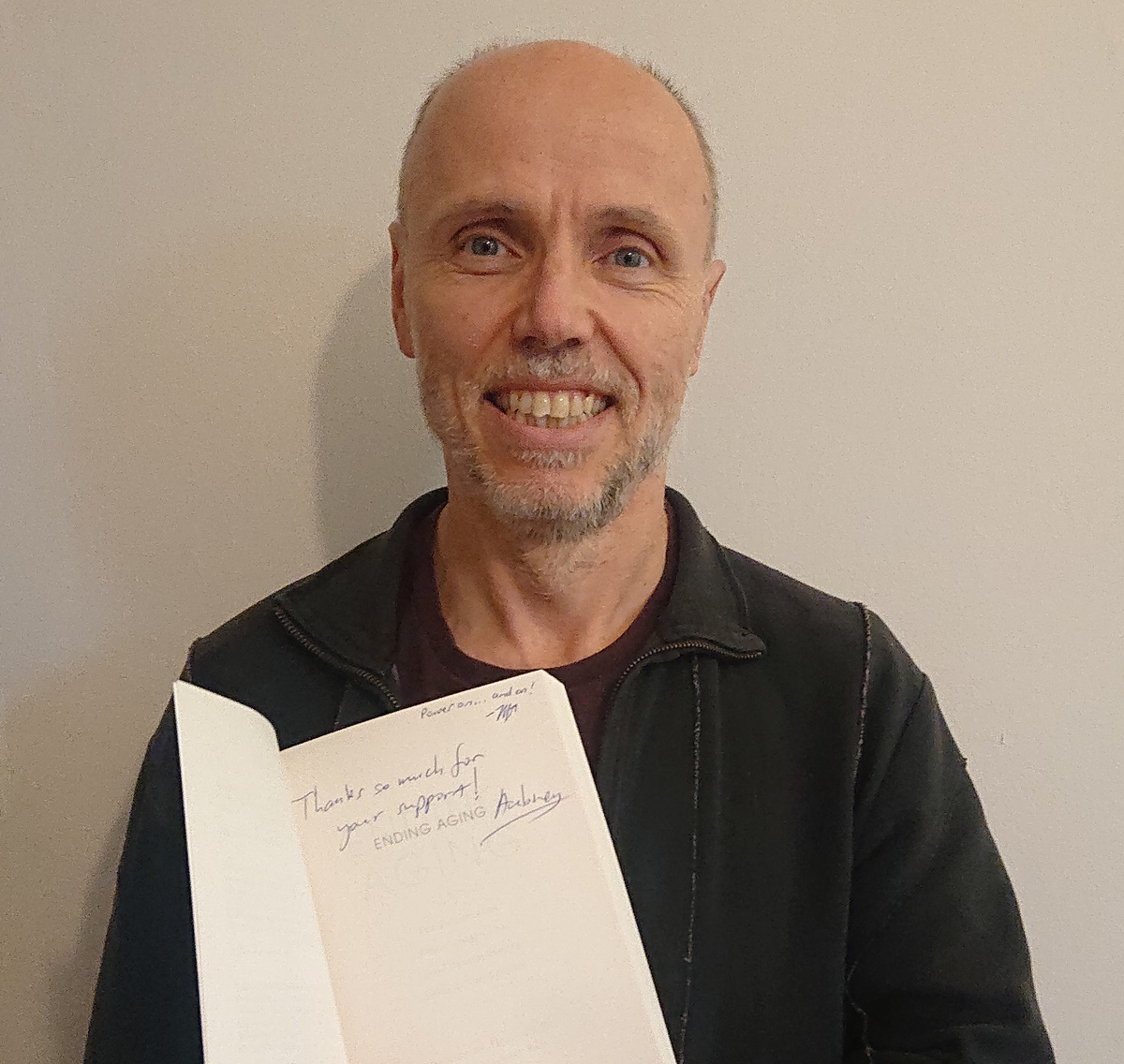 Adrian Cull with signed copy of ending aging by Aubrey de Grey
